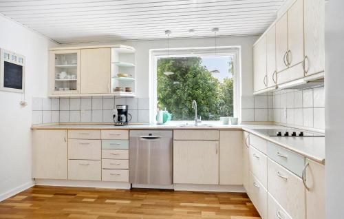 a kitchen with white cabinets and a window at Lovely Home In Højslev With Wifi in Højslev
