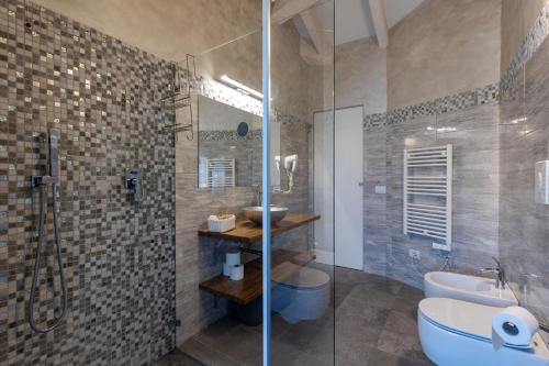 a bathroom with a shower and a toilet and a sink at Villa Vitali - Bellagio in Bellagio