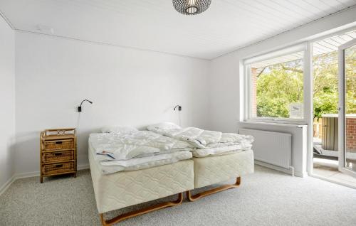 a white bedroom with a bed and a window at Lovely Home In Højslev With Wifi in Højslev