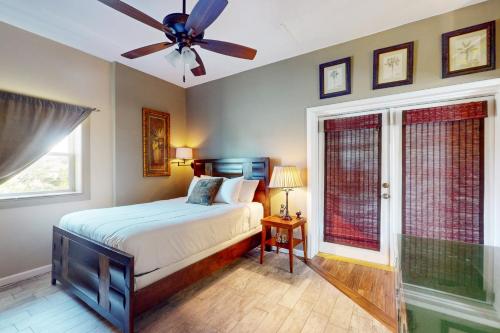 a bedroom with a bed and a ceiling fan at Mermaid Haven in Mexico Beach