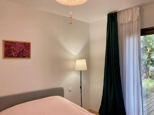 a bedroom with a bed and a window at Villa 53 Beach House Médoc in Le Verdon-sur-Mer