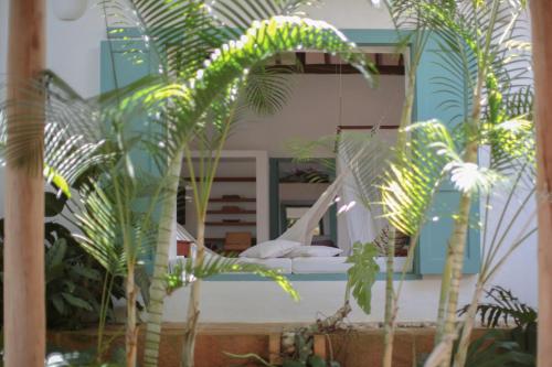 a bedroom with a hammock in a room with plants at Casa Barichara Boutique in Barichara