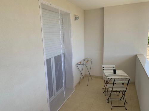 a room with a table and chairs and a window at Loremi Rooms in Termoli