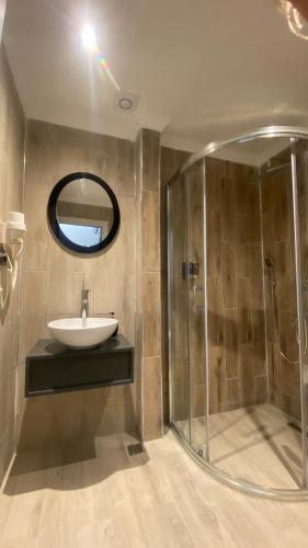 a bathroom with a sink and a shower at Green Nazar Hotel in Trabzon