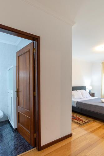 a bedroom with a bed and a large mirror at Retreat Hattie's Beach in Arcozelo