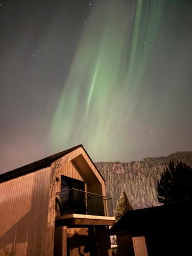 a building with a balcony with the northern lights in the sky at Chalet Orkanger cozy central unique in Orkanger