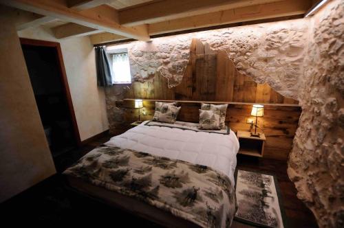 a bedroom with a large bed in a room at Chalet Pra Dell OSTIO Primiero San Martino di Castrozza in Fiera di Primiero