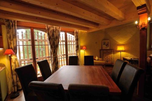 a dining room with a large wooden table and chairs at Chalet Pra Dell OSTIO Primiero San Martino di Castrozza in Fiera di Primiero