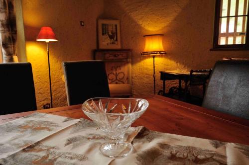 a wine glass sitting on top of a wooden table at Chalet Pra Dell OSTIO Primiero San Martino di Castrozza in Fiera di Primiero