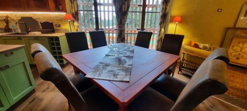 a dining room with a wooden table and chairs at Chalet Pra Dell OSTIO Primiero San Martino di Castrozza in Fiera di Primiero