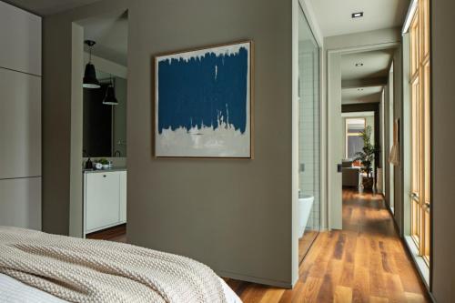 a bedroom with a bed and a painting on a wall at Idyll Reserve - Hocking Hills in South Bloomingville