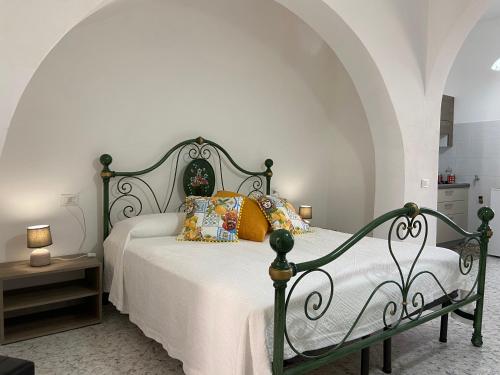 a bedroom with a bed with pillows on it at Case Gandolfo in Favignana