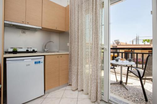 a kitchen with a dishwasher and a table with a patio at il Centro Studios in Potos