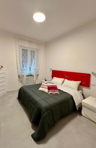 um quarto com uma cama grande e uma cabeceira vermelha em Birimari house em Arezzo
