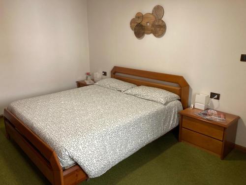 a bedroom with a bed and a table with a lamp at Al Civico 40 in Fai della Paganella