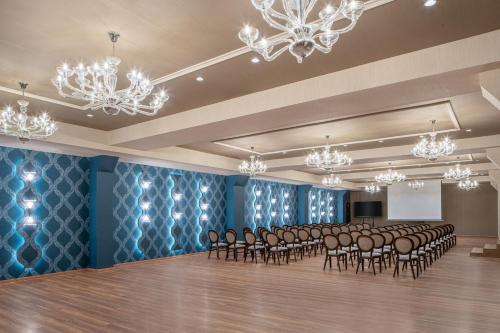 a conference room with chairs and a podium in the middle at Sky Blue Hotel & Spa in Ploieşti