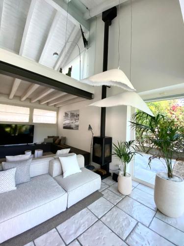 a living room with a couch and a tv at Jesolo Beach Villa in Lido di Jesolo