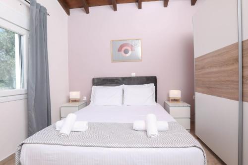a bedroom with a large white bed with white pillows at Luxury and Tranquility - Halicouna's Perfect Gem in Halikounas