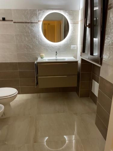 a bathroom with a sink and a mirror at Dimora Valentina in Tricase