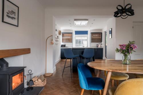 a kitchen and dining room with a table and a fireplace at Crossriggs- Beautiful Detached Home in Windermere