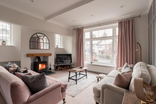 a living room with two couches and a fireplace at Crossriggs- Beautiful Detached Home in Windermere
