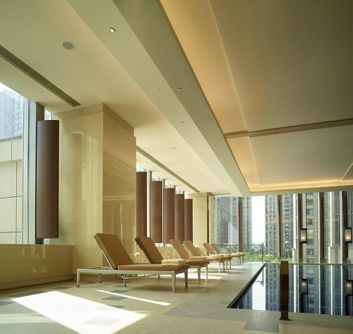 a row of chairs in a room with windows at Shangri-La Tangshan in Tangshan