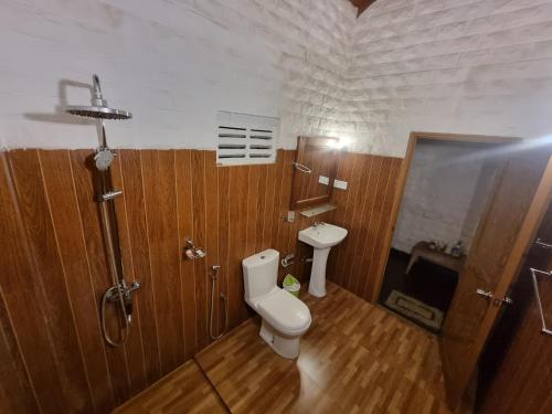 a bathroom with a toilet and a sink at Liyon Rest sigiriya in Sigiriya