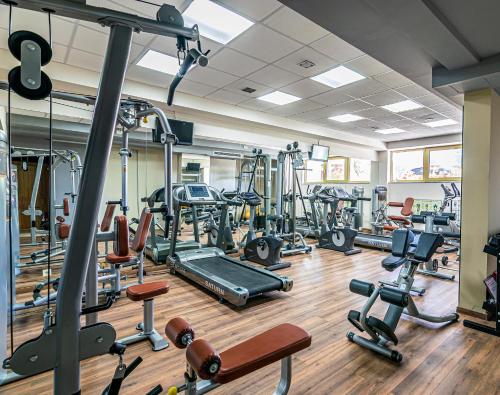 a gym with a lot of treadmills and machines at Golden Rooms in Ioannina