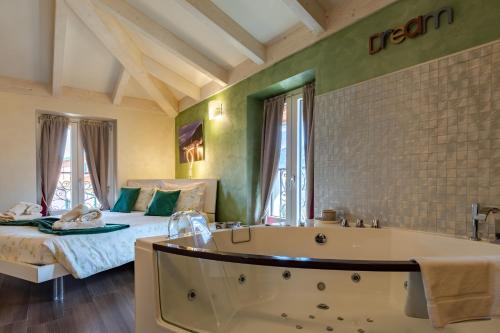 a large bathroom with a tub and a bed at Villa Vitali - Bellagio in Bellagio