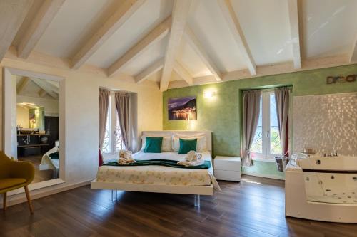 a bedroom with a bed with green walls and windows at Villa Vitali - Bellagio in Bellagio