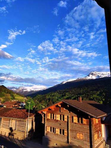 a view of snow capped mountains from a house at Gasthaus zum Rathaus in Saas