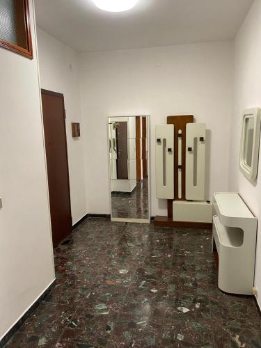 a bathroom with two urinals and mirrors in a room at Blue Sea House in Chioggia