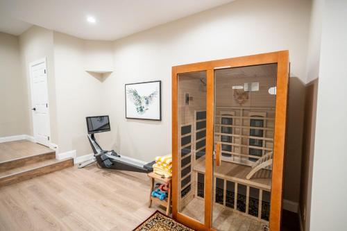 a home gym with a glass door and a treadmill at Pipers Paradise in Beech Mountain