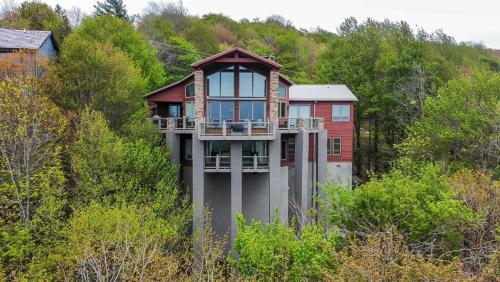 a house in the middle of a hill with trees at Pipers Paradise in Beech Mountain