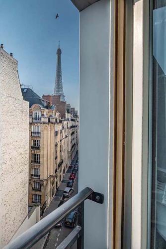 a view of the eiffel tower from a balcony at Hôtel le Derby Alma by Inwood Hotels in Paris
