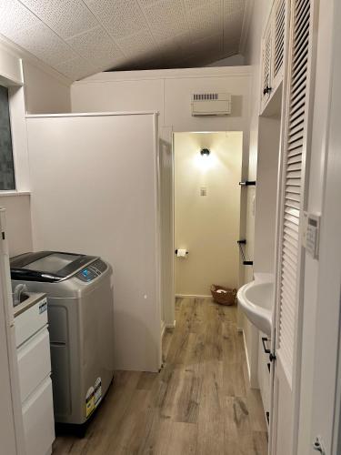 a small bathroom with a sink and a toilet at Beachfront Favourite - Foxton Beach Holiday Home in Foxton Beach