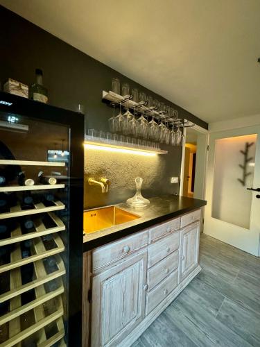 a kitchen with a counter with wine glasses on the wall at Arnlod's nest in Kotlje