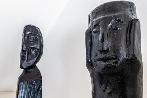 a black figurine of a statue of a man at Arnlod's nest in Kotlje