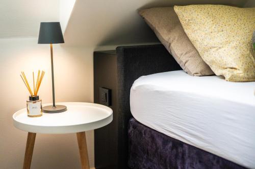 a bedroom with a bed and a table with a lamp at Arnlod's nest in Kotlje
