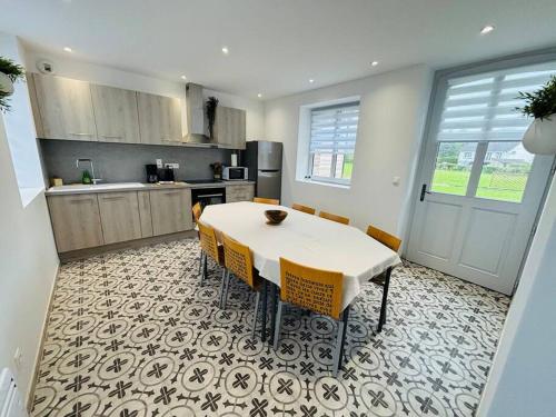 une cuisine avec une table blanche et des chaises jaunes dans l'établissement Domaine Michel Ange baie de Somme, à Caours
