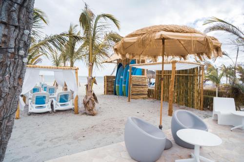 a resort with chairs and an umbrella on the beach at Radisson Riviera Panama in Punta Chame