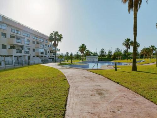 a walkway in front of a building with a skate park at Toyo Alcazaba Suites Gran terraza y vistas, 2Hab, piscina y garaje in Retamar