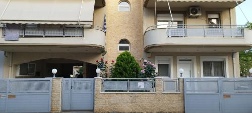 a building with a gate and a fence in front of it at V2 LUX Apartment in Alexandroupoli
