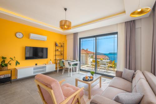 a living room with a couch and a tv at Meri Suite Apart Kaş in Kas
