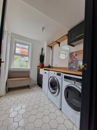 a laundry room with a washer and a window at Lovely 3 bedroom Whitley Bay Townhouse. in Whitley Bay