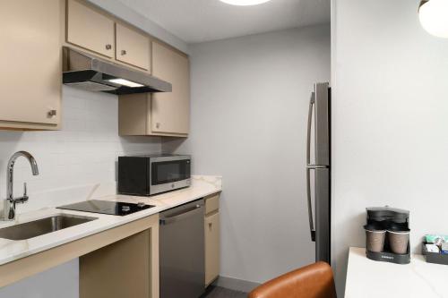 a small kitchen with a sink and a refrigerator at Homewood Suites by Hilton Chester in Chester