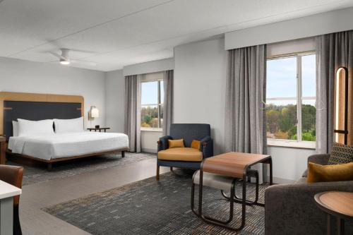 a hotel room with a bed and a couch at Homewood Suites by Hilton Chester in Chester