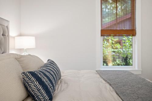 a bedroom with a bed with a pillow and a window at Bella and Dulce's Lakehouse in Union Pier