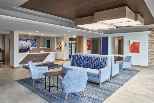 a lobby with a couch and chairs and a table at Holiday Inn Express - Akron NW - Fairlawn, an IHG Hotel in Akron