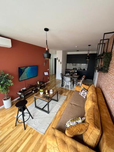 a living room with a couch and a table at Lux apartment 13 center, free parking in Niš